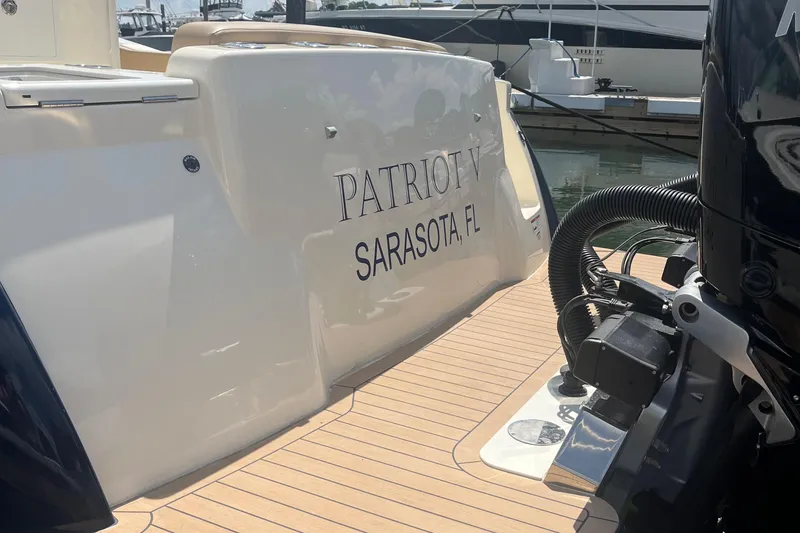 Slide: The Image of 2024 Scout 330 LXF boat docked, featuring "Patriot V" from Sarasota, FL. - 11
