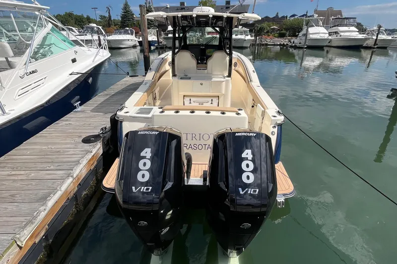 Slide: The Image of 2024 Scout 330 LXF boat with twin Mercury 400 V10 engines docked at marina. - 13