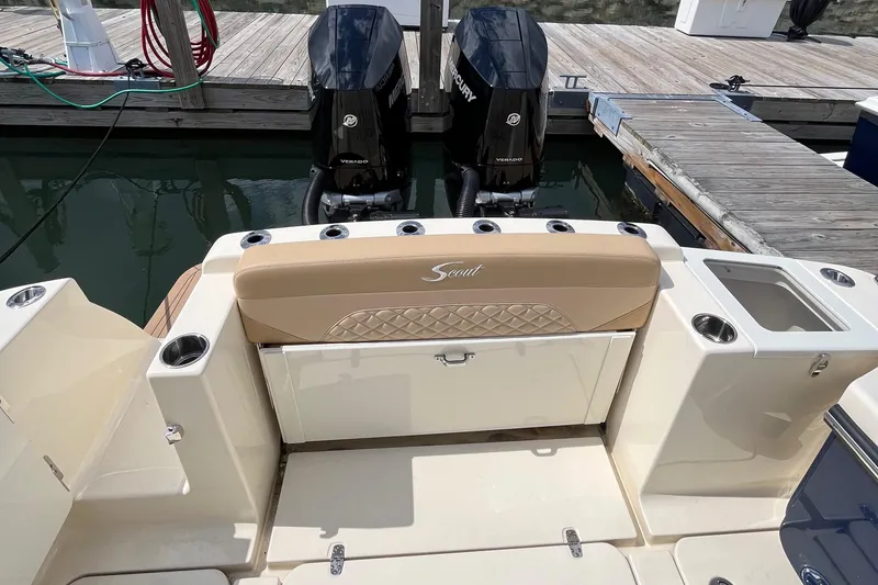 Slide: The Image of 2024 Scout 330 LXF boat with dual Mercury engines at dock. - 18