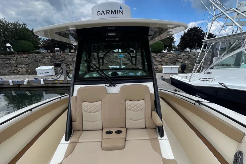 Slide: The Image of 2024 Scout 330 LXF boat with Garmin equipment, docked at marina. - 27