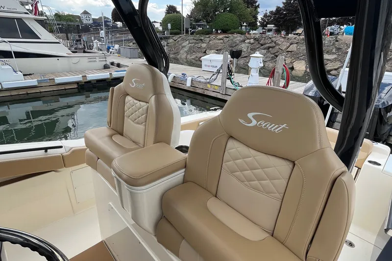 Slide: The Image of 2024 Scout 330 LXF boat seats with quilted design at marina. - 29