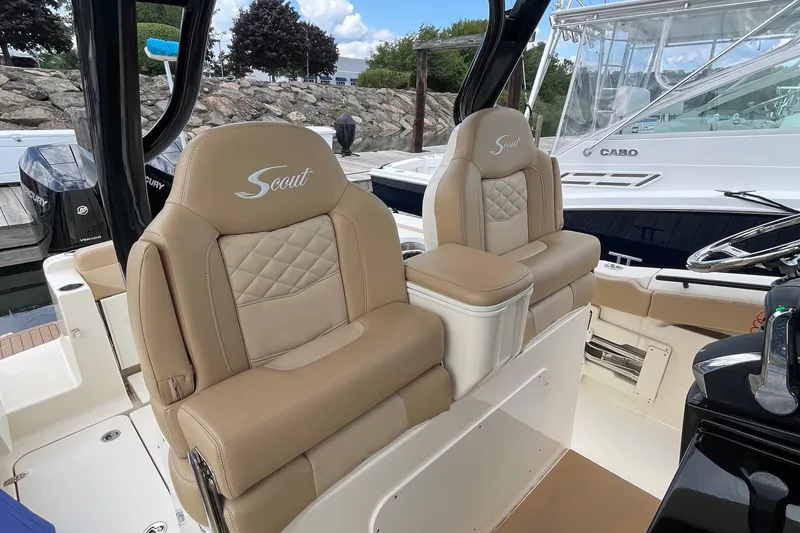Slide: The Image of 2024 Scout 330 LXF boat interior with luxurious tan seating and elegant design. - 30