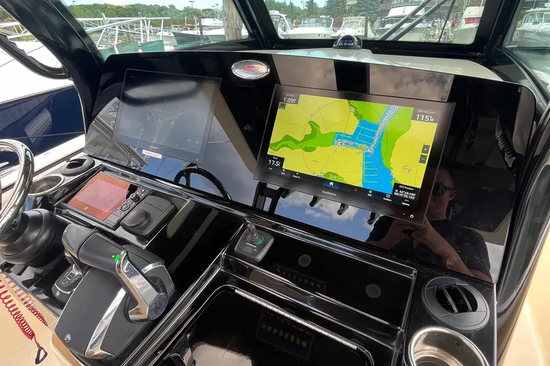 Slide: The Image of 2024 Scout 330 LXF boat dashboard with navigation screens and controls. - 31