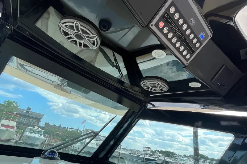 Slide: The Image of Interior view of 2024 Scout 330 LXF boat with speakers and control panel. - 35