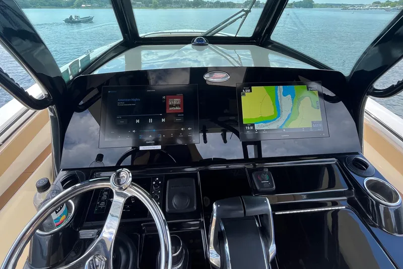 Slide: The Image of 2024 Scout 330 LXF boat dashboard with navigation and entertainment screens. - 37