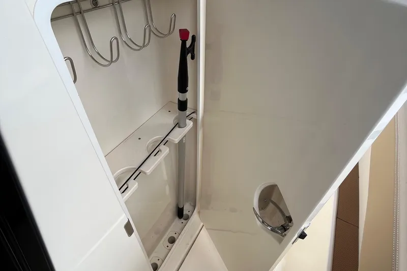 Slide: The Image of 2024 Scout 330 LXF storage compartment with fishing rod holders. - 40