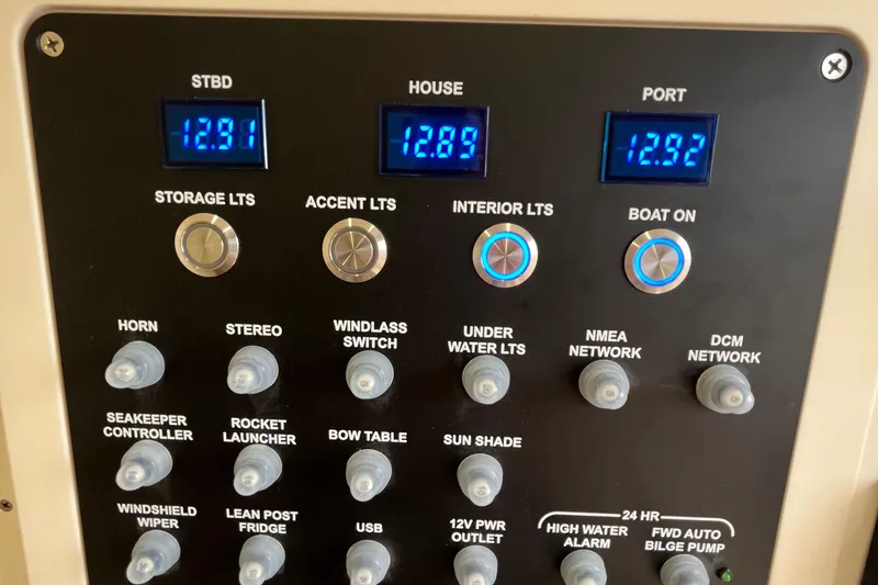 Slide: The Image of Control panel of 2024 Scout 330 LXF boat with digital displays and switches. - 42