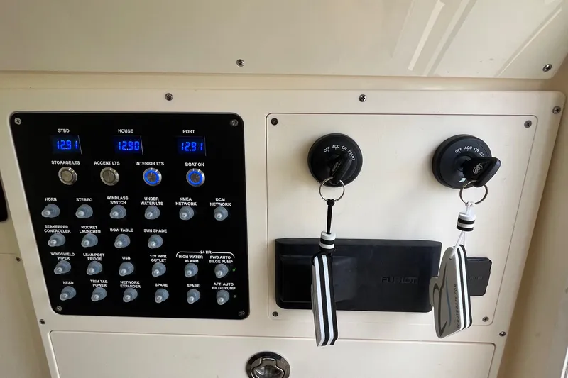Slide: The Image of Control panel of 2024 Scout 330 LXF boat with ignition keys and switches. - 43