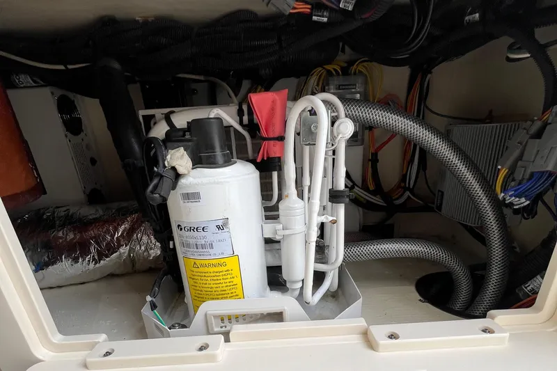 Slide: The Image of 2024 Scout 330 LXF boat engine compartment with wiring and components. - 48