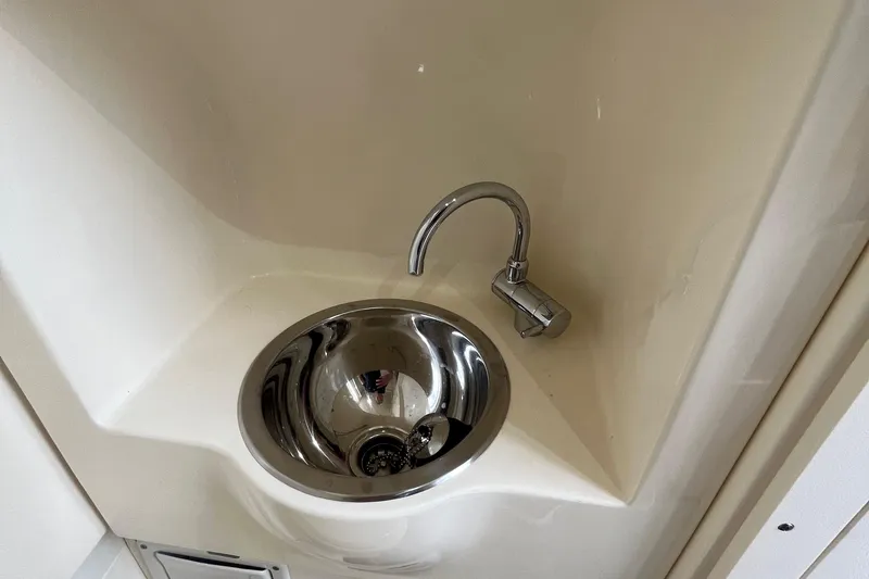 Slide: The Image of Stainless steel sink in 2024 Scout 330 LXF boat interior. - 49