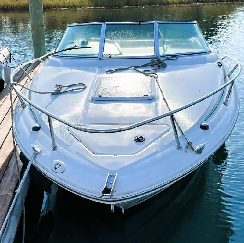 Slide: The Image of 2001 Sea Ray 225 Weekender boat docked on calm water. - 1