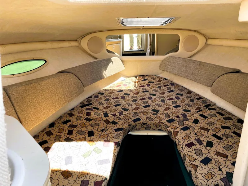 Slide: The Image of Interior cabin of 2001 Sea Ray 225 Weekender with patterned upholstery and side windows. - 12