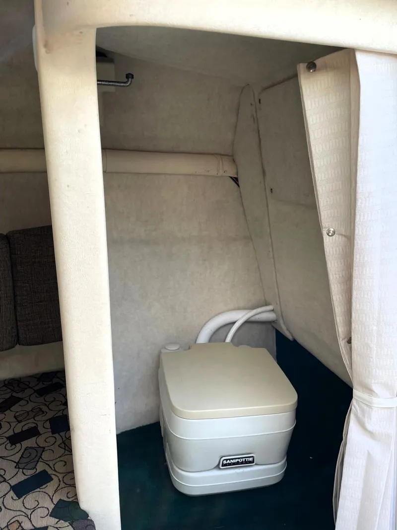 Slide: The Image of 2001 Sea Ray 225 Weekender cabin interior with portable toilet. - 13