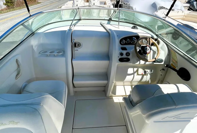 Slide: The Image of 2001 Sea Ray 225 Weekender boat interior with steering wheel and seating area. - 15