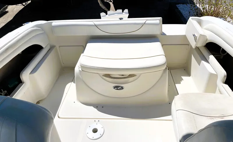 Slide: The Image of 2001 Sea Ray 225 Weekender boat interior with white seating and storage compartments. - 16