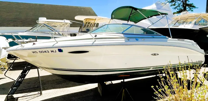 Slide: The Image of 2001 Sea Ray 225 Weekender boat displayed outdoors on a sunny day. - 2