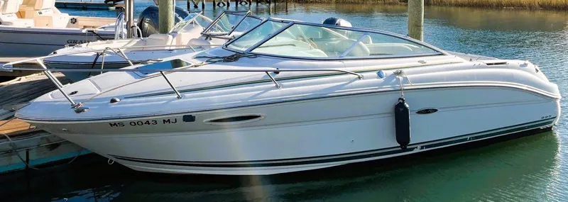 Slide: The Image of 2001 Sea Ray 225 Weekender boat docked in a marina, side view. - 3