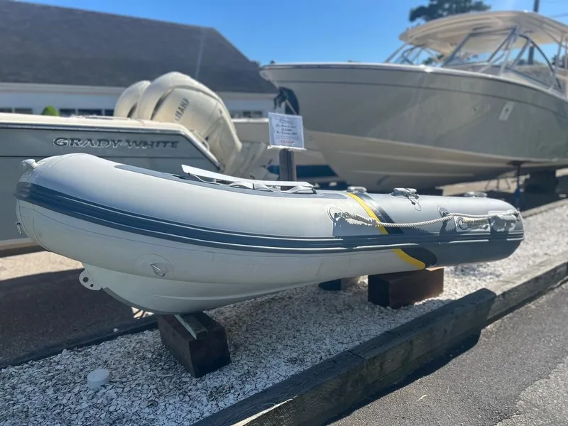 Slide: The Image of 2021 North Atlantic Inflatables ALA300 with Yamaha F8 engine displayed outdoors. - 5