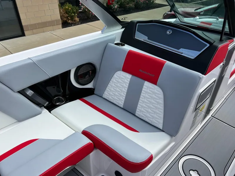 Slide: The Image of 2023 MasterCraft X24 boat interior with red and gray seating, modern design. - 10