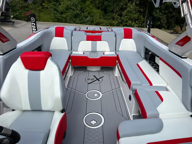 Slide: The Image of 2023 MasterCraft X24 boat interior with red and gray seating, modern design. - 11