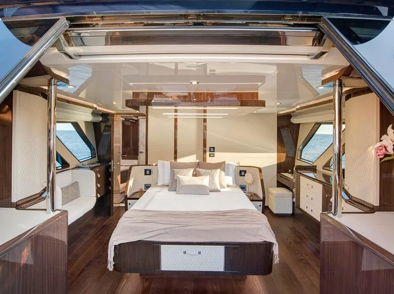 Slide: The Image of Luxurious 2023 Lazzara LSX 67 yacht bedroom with elegant wood finishes and panoramic windows. - 19