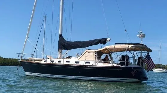 Slide: The Image of Sailboat on water, Tartan 4100, 1998 model, with American flag, clear sky. - 10