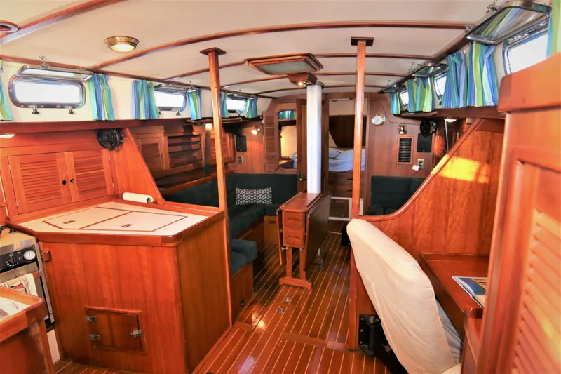 Slide: The Image of Interior of a 1998 Tartan 4100 sailboat with wooden furnishings and striped curtains. - 11