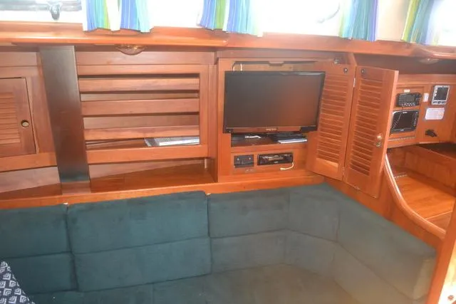 Slide: The Image of Interior of 1998 Tartan 4100 yacht with wood paneling and built-in electronics. - 17