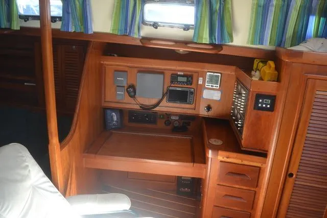 Slide: The Image of Interior of a 1998 Tartan 4100 sailboat with navigation equipment and wooden cabinetry. - 21