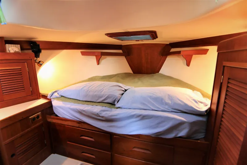 Slide: The Image of Cozy cabin interior of 1998 Tartan 4100 sailboat with wooden furnishings and comfortable bedding. - 23