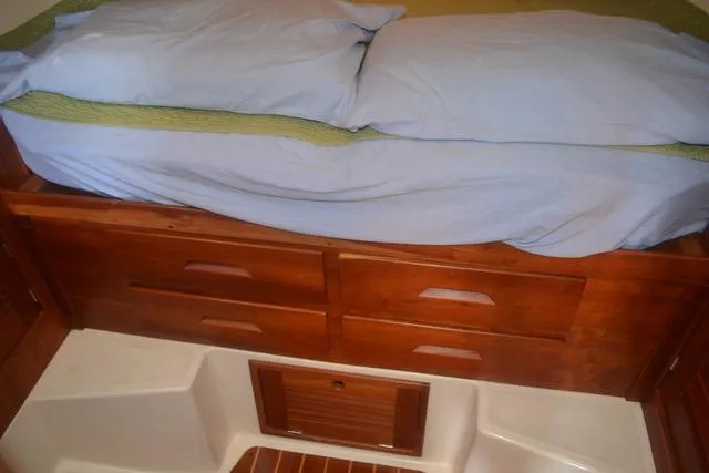 Slide: The Image of Interior of 1998 Tartan 4100 sailboat with wooden drawers and bed. - 24