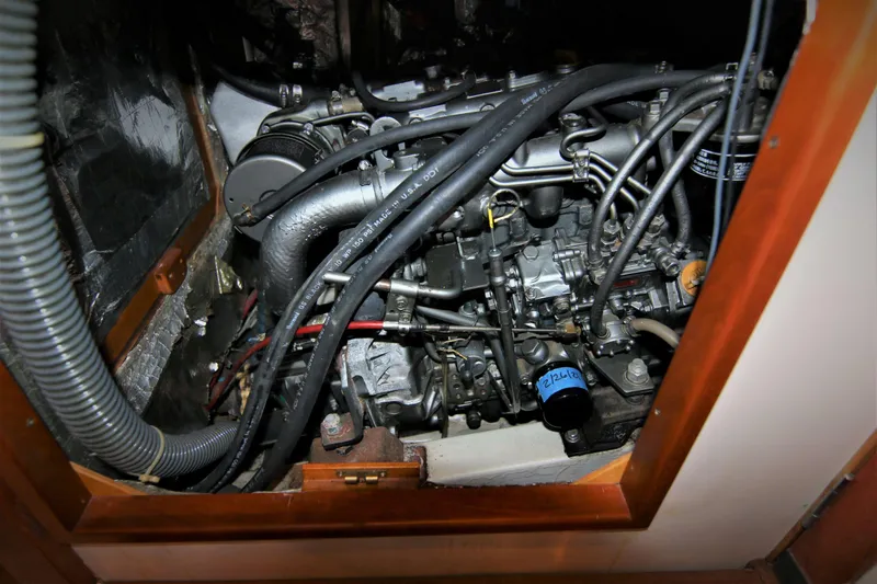 Slide: The Image of Engine compartment of a 1998 Tartan 4100 sailboat, showcasing intricate mechanical components. - 32