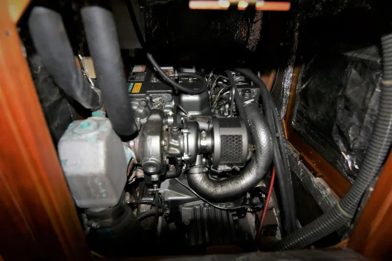 Slide: The Image of Engine compartment of a 1998 Tartan 4100 sailboat, showcasing mechanical components and hoses. - 33