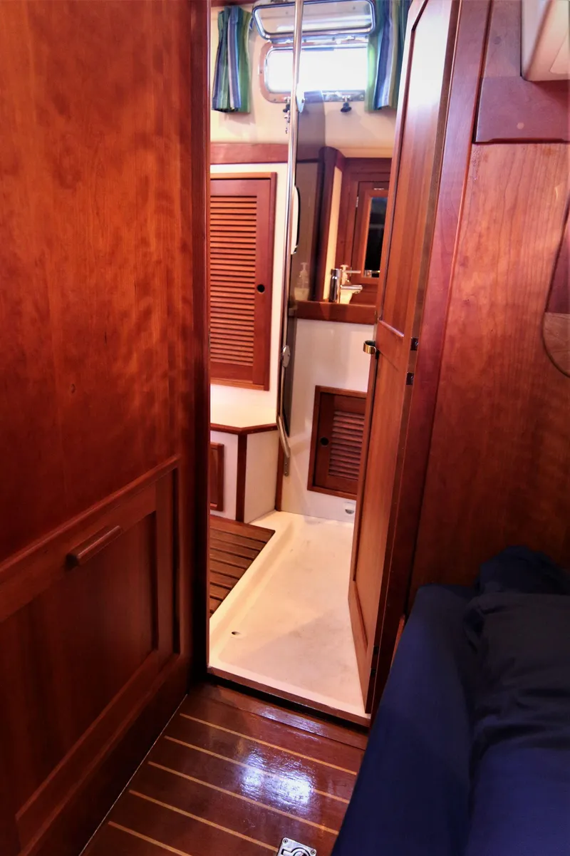 Slide: The Image of Interior of 1998 Tartan 4100 sailboat with wooden cabinetry and flooring. - 34