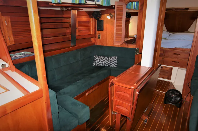 Slide: The Image of Interior of 1998 Tartan 4100 sailboat with wooden furnishings and green seating. - 36