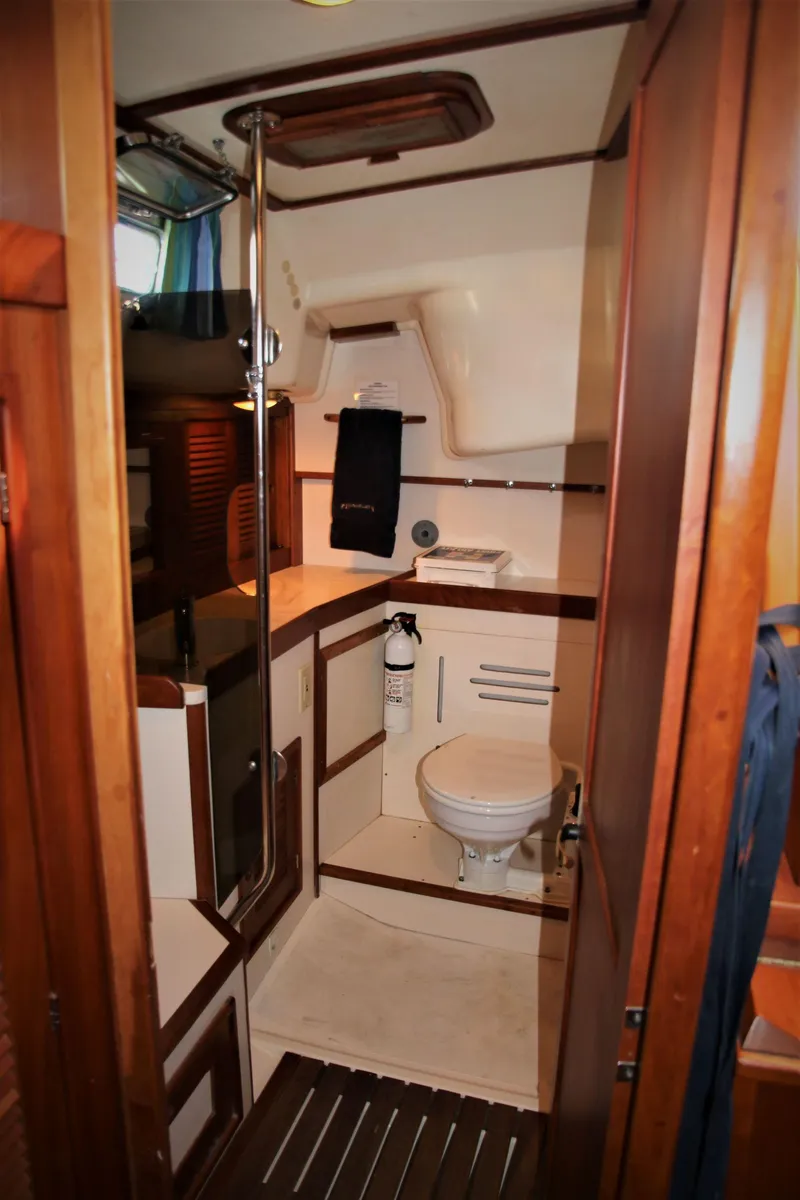 Slide: The Image of 1998 Tartan 4100 yacht bathroom with wooden accents and compact design. - 39