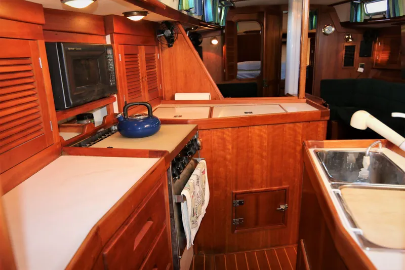 Slide: The Image of Interior of 1998 Tartan 4100 yacht kitchen with wooden cabinetry and modern appliances. - 41