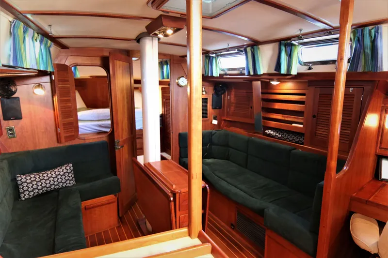 Slide: The Image of Interior of 1998 Tartan 4100 sailboat with wood finish and green upholstery. - 43