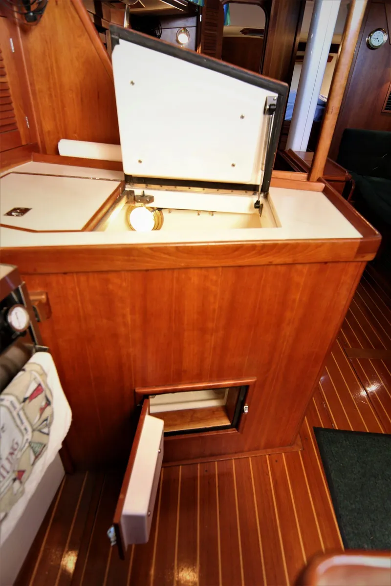 Slide: The Image of Interior of 1998 Tartan 4100 yacht with wooden cabinetry and open storage compartments. - 45