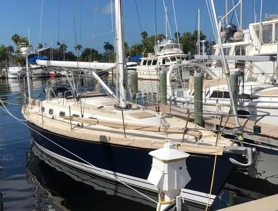 Slide: The Image of 1998 Tartan 4100 sailboat docked at a marina, surrounded by other boats. - 7