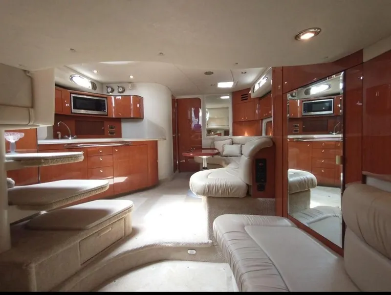 The Image of Luxurious interior of 2001 Sea Ray 380 Sundancer yacht with modern kitchen and seating area. - 0