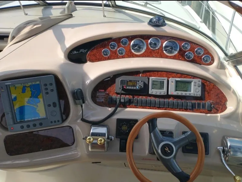 Slide: The Image of 2001 Sea Ray 380 Sundancer dashboard with navigation equipment and steering wheel. - 11