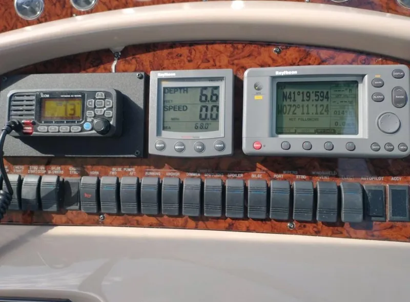 Slide: The Image of Control panel of a 2001 Sea Ray 380 Sundancer with navigation and communication instruments. - 13