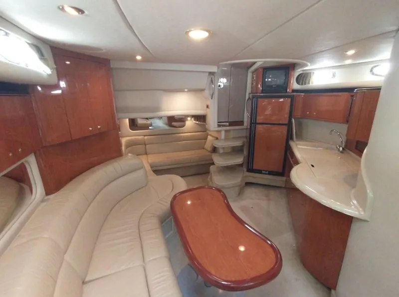 Slide: The Image of Luxurious interior of 2001 Sea Ray 380 Sundancer yacht with elegant seating and kitchenette. - 2