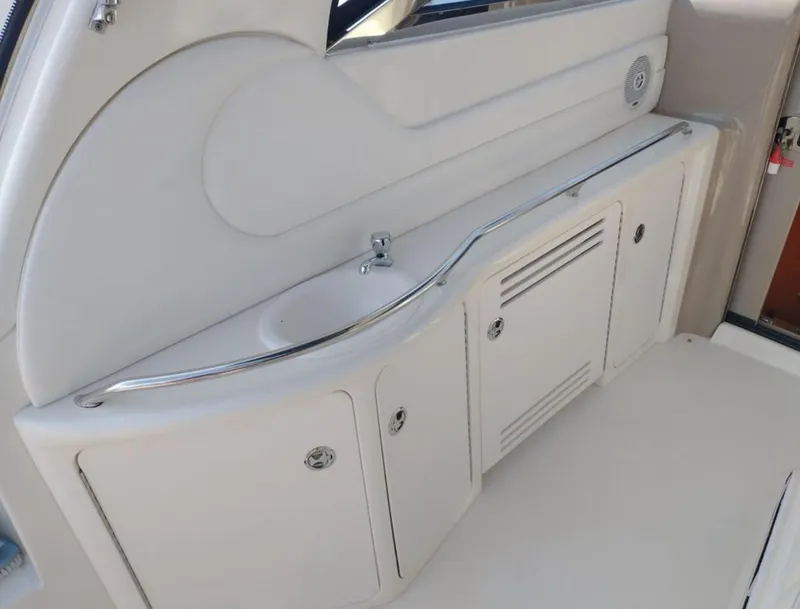 Slide: The Image of 2001 Sea Ray 380 Sundancer interior with sink and storage cabinets. - 8