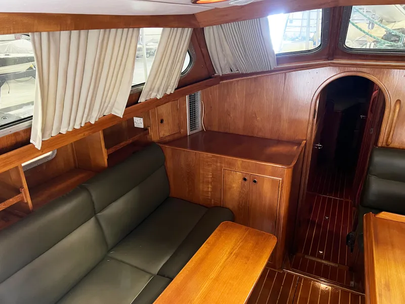 Slide: The Image of Interior of 1987 Oyster 46.5 yacht with wood finish and leather seating. - 10