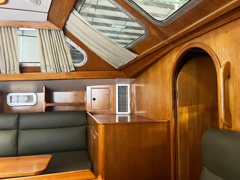 Slide: The Image of Interior of 1987 Oyster 46.5 yacht with wood paneling and seating. - 12