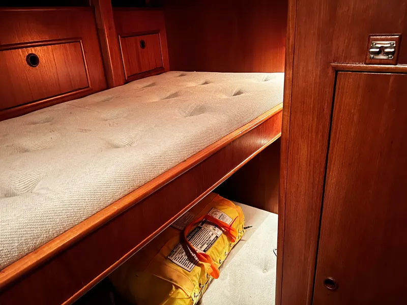 Slide: The Image of Cozy cabin interior of 1987 Oyster 46.5 yacht with wooden finish and storage space. - 15