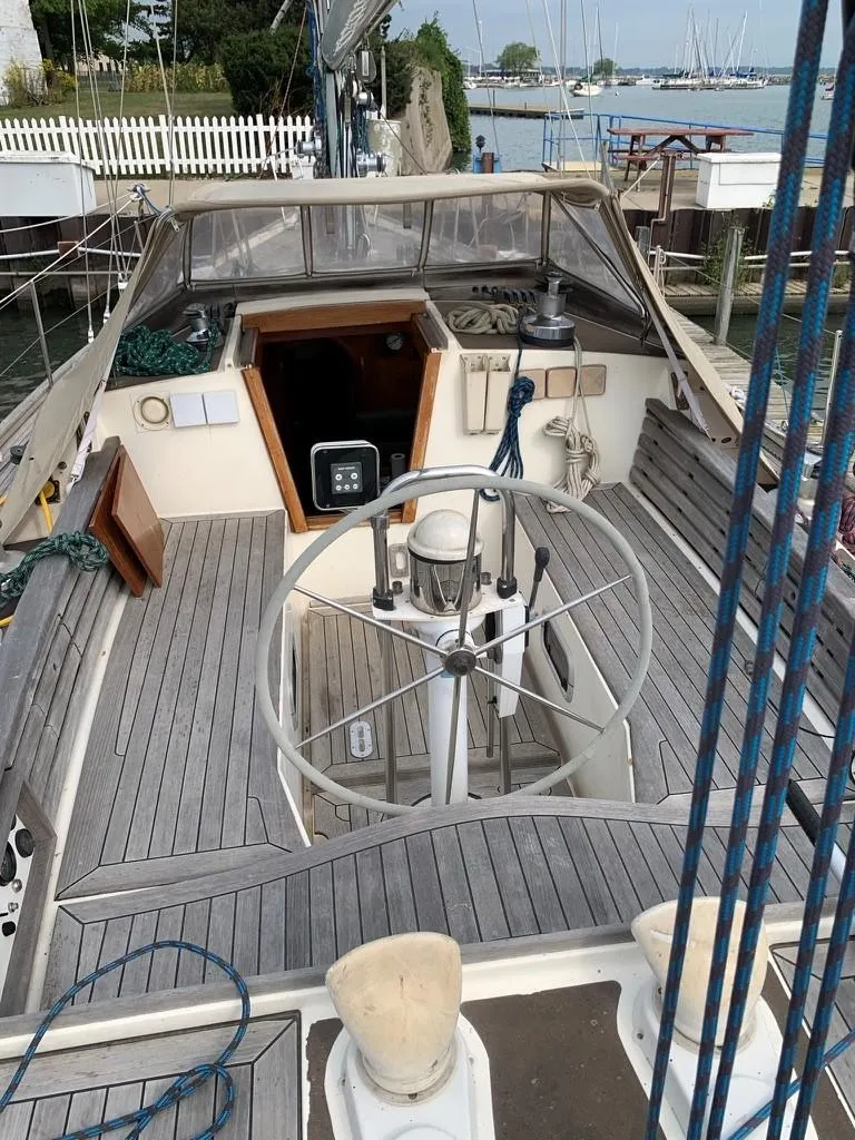 Slide: The Image of 1987 Oyster 46.5 sailboat cockpit with wooden deck and steering wheel. - 2