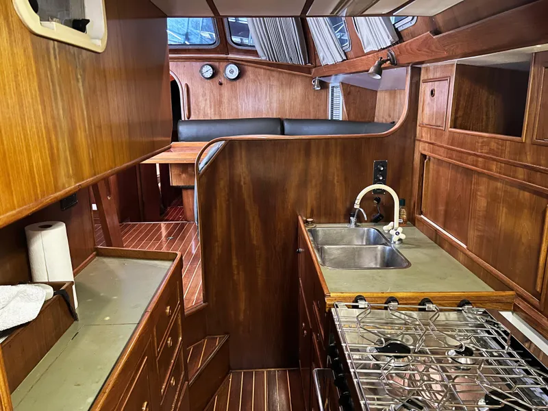 Slide: The Image of Interior of 1987 Oyster 46.5 yacht with wooden cabinetry and modern kitchen amenities. - 20